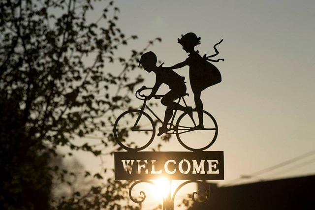 two bicyclists welcome sign
