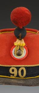 Photo 2 : SHAKO OF THE 90th INFANTRY REGIMENT, 1st BATTALION, model 1868, Second Empire. Inventory number 31235R.