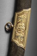 Photo 7 : Gold sabre by the Austrian cutler Kolbe with the cipher of Emperor Napoleon, First Empire, circa 1810. PHILIPPE MISSILLIER COLLECTION, Giquello auction house, Drouot - rooms 5-6, March 6 & 7, 2025.