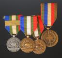 QUATRE DÉCORATIONS DE L'UNION NATIONALES DES COMBATTANTS, Troisième République - Quatrième République. 29788-82-83-84-85R