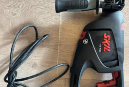 Location outil Perceuse à percussion électrique Skil près de Créhen