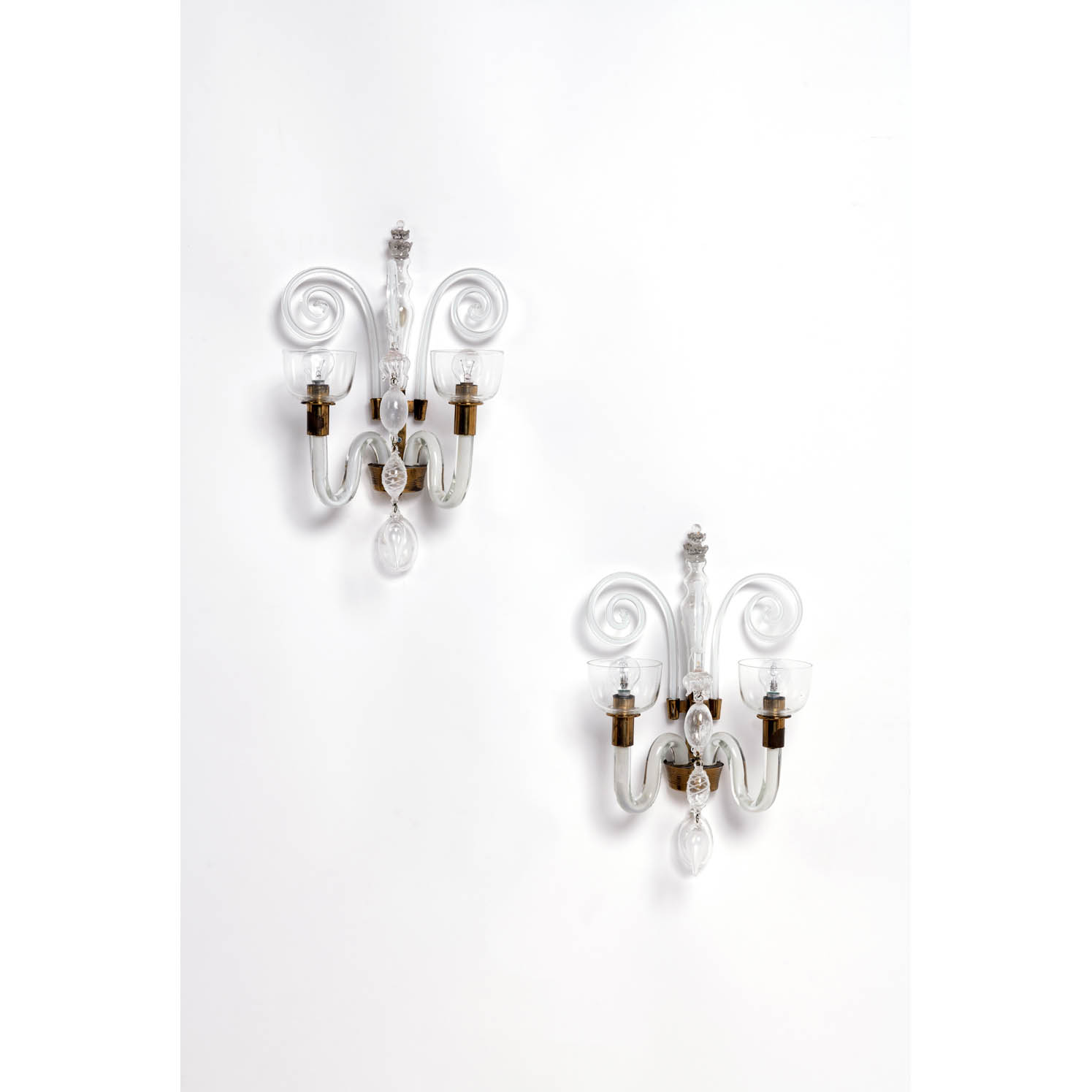 Carlo Scarpa (1906-1978) Model n&deg; 5315 Estimation : 5000 / 7000 &euro; Carlo Scarpa (1906-1978) Model n&deg; 5315 Pair of sconces Brass, Lattimo glass and clear glass Venini edition Inscribed with &ldquo;Venini-Murano&rdquo; on the mountings Creation date: circa 1940 H 37,5 &times; L 30 &times; P 19cm Bibliography: - Venini Catalogue bleu, model n&deg; 5315