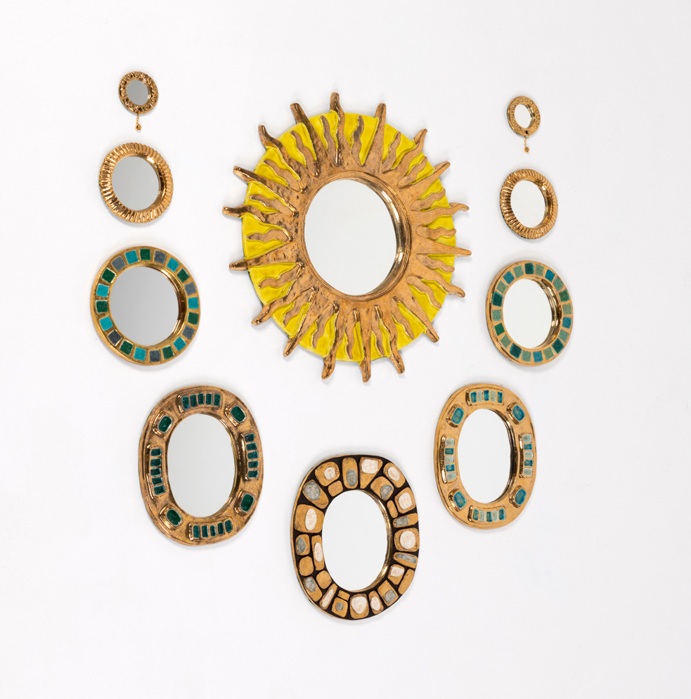 Mithé Espelt (1923-2020) Set of ten mirrors with: - 'Feu' mirror Glazed ceramic enhanced with gold Model created in the 1980s Ø 56 cm - 'Abalone' mirror Glazed ceramic enhanced with gold and pâte de verre Model created circa 1978 H 31 × Ø 28,5 cm