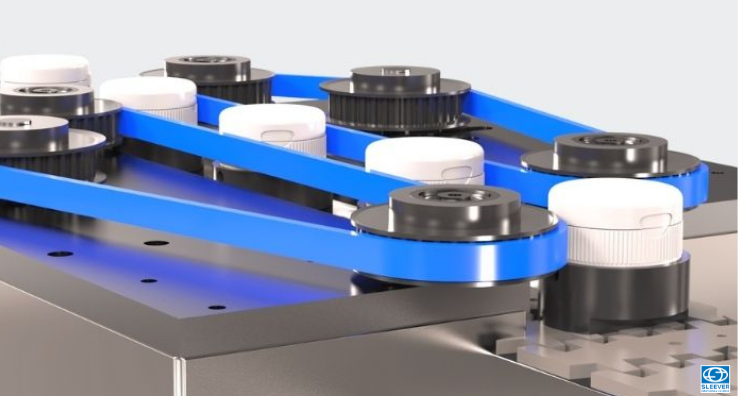 An orientation module allows the flip top caps capsules to be aligned perpendicularly to the Sleeve's opening system to ensure the precise placement of the tamper-evident banding
