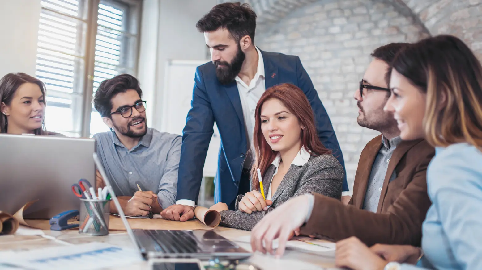 Team of people working on Microsoft platform in a modern office