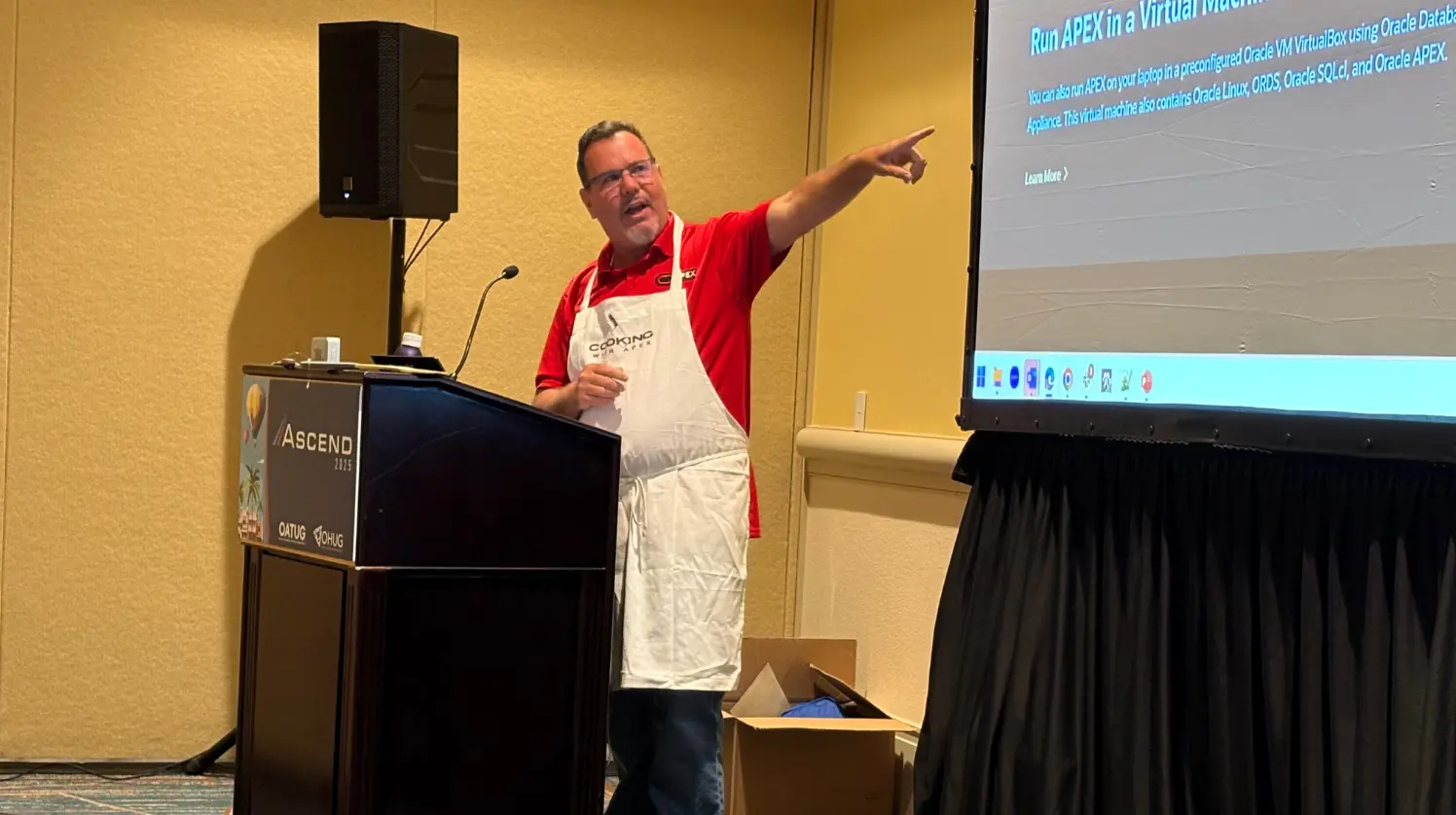 Talan expert at Ascend2025 giving a speech with a an event apron on