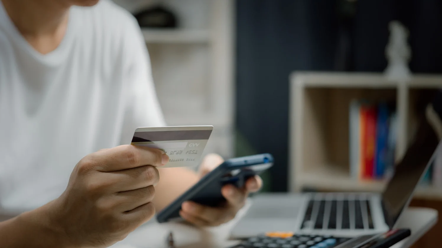 A man uses his card to purchase an item from a retail online shop