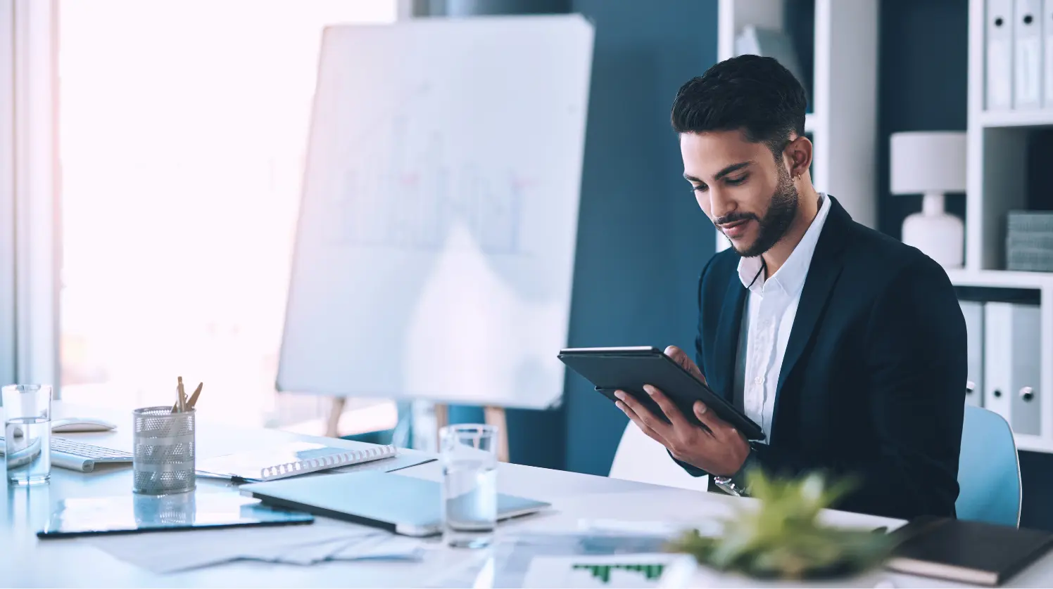 A young manager looks at an ERP interface for manufacturing at an office