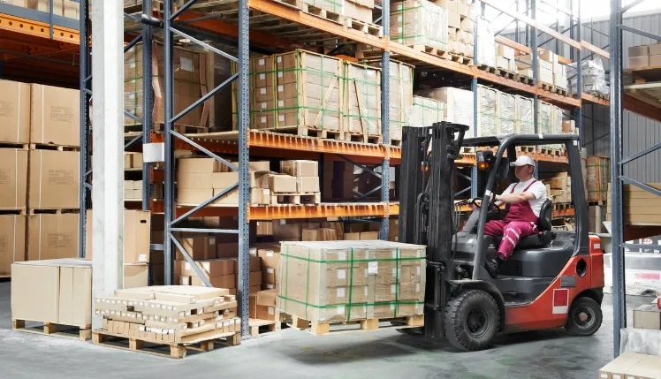 Worker driver at warehouse forklift loader works