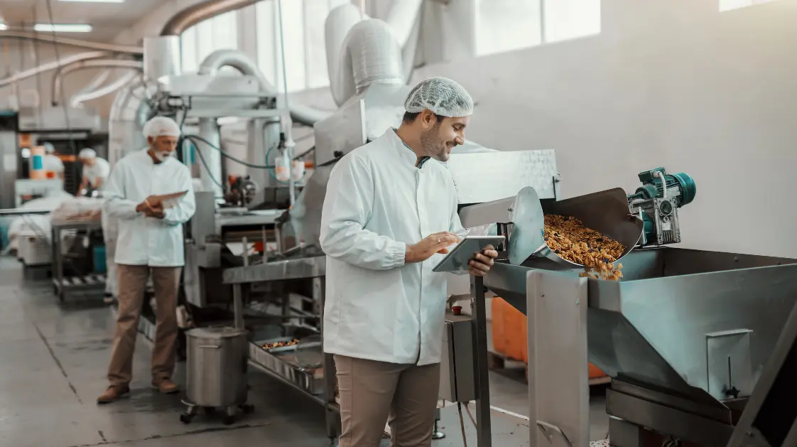 A granola and cereal manufacturing plant where a worker is inspecting a granola production line