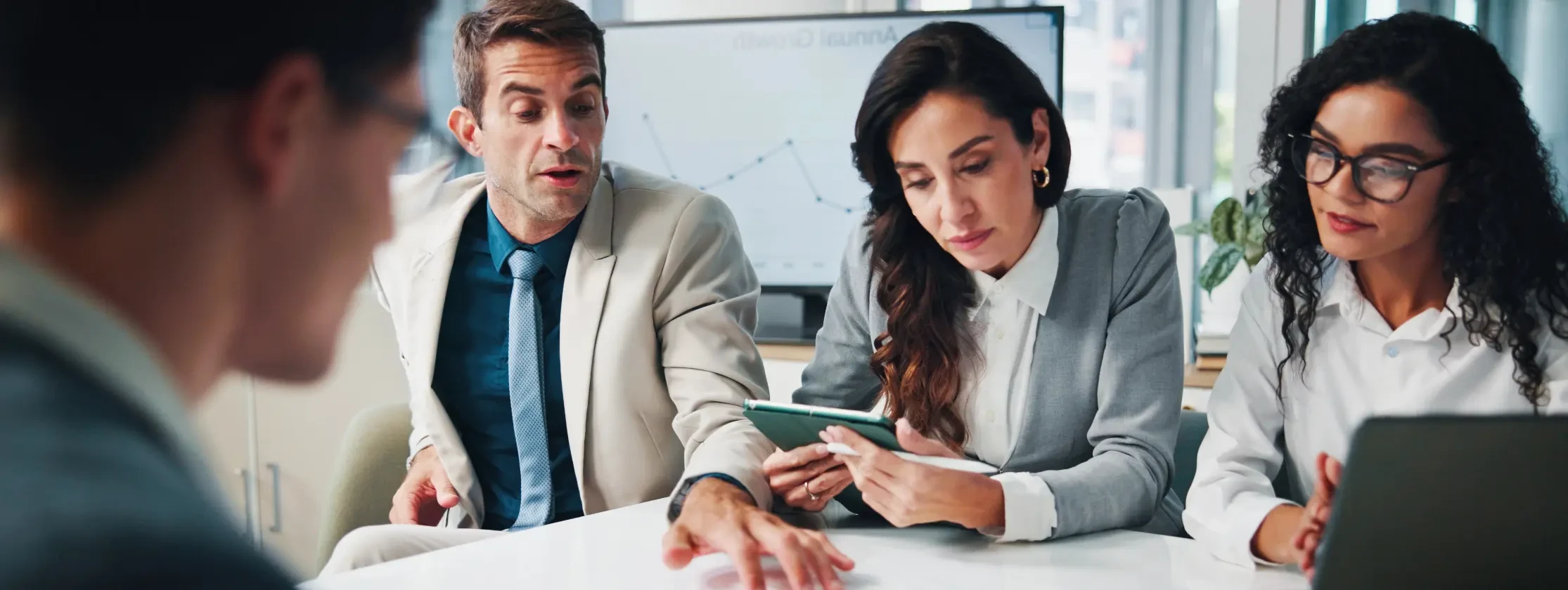 A modern team in a meeting discussing some information by going through some papers