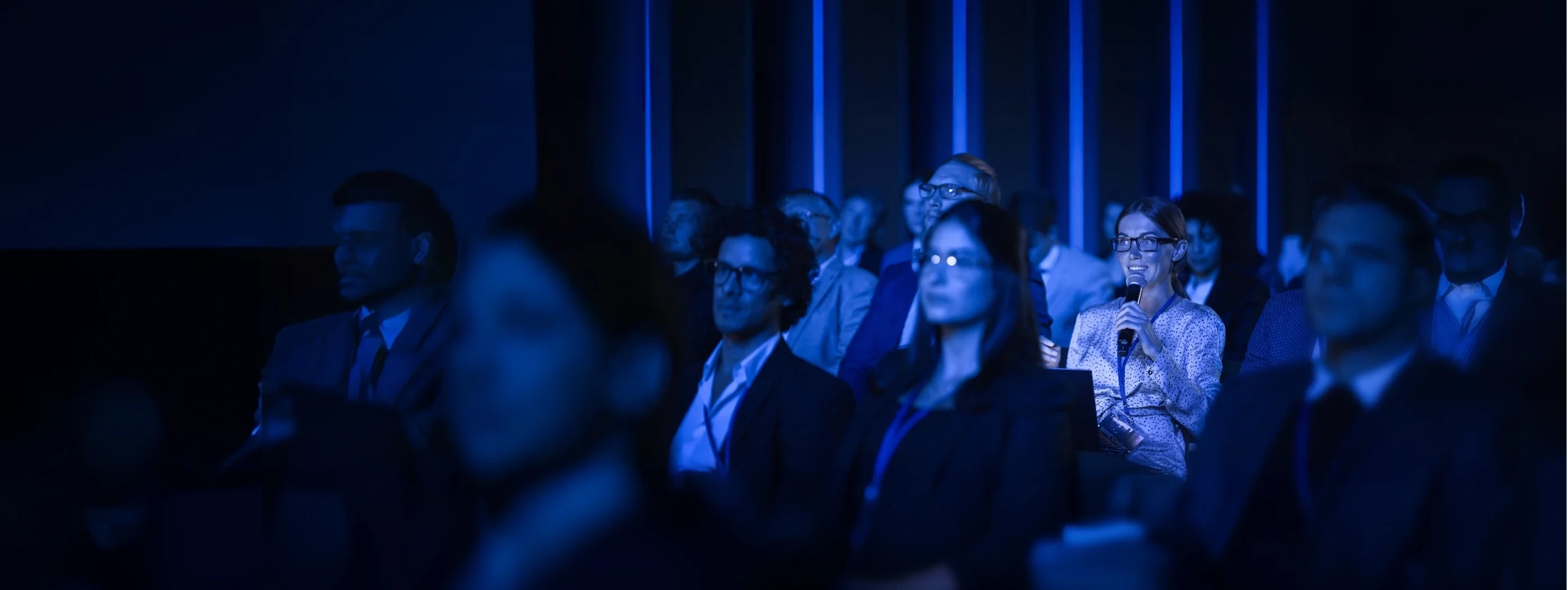 Female Asking a Question to a Speaker During a Q and A Session 