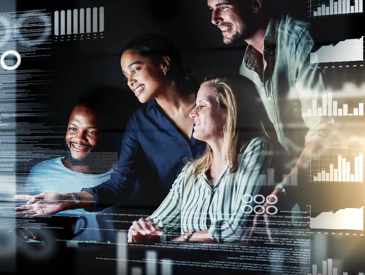 A diverse oracle development team gathers around computers going over some codes