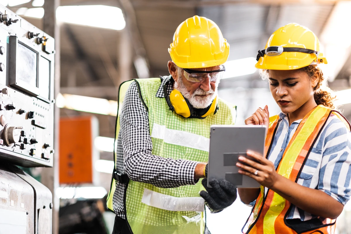 Industrial Engineers in Hard Hats working at the Heavy Industry Manufacturing Factory.