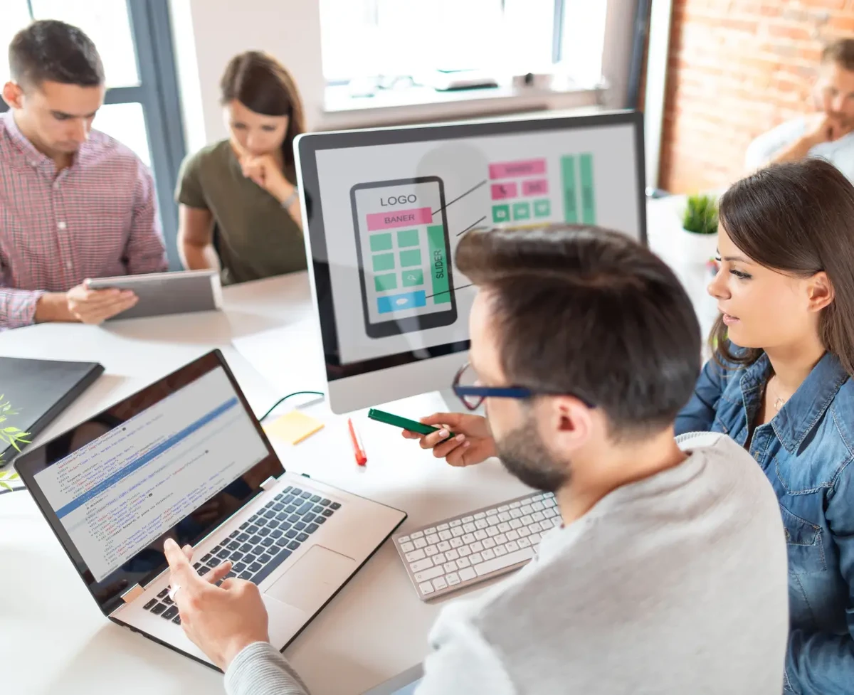 Designers developing a redesign for a website development project by creating UX layout and building a front-end based on that