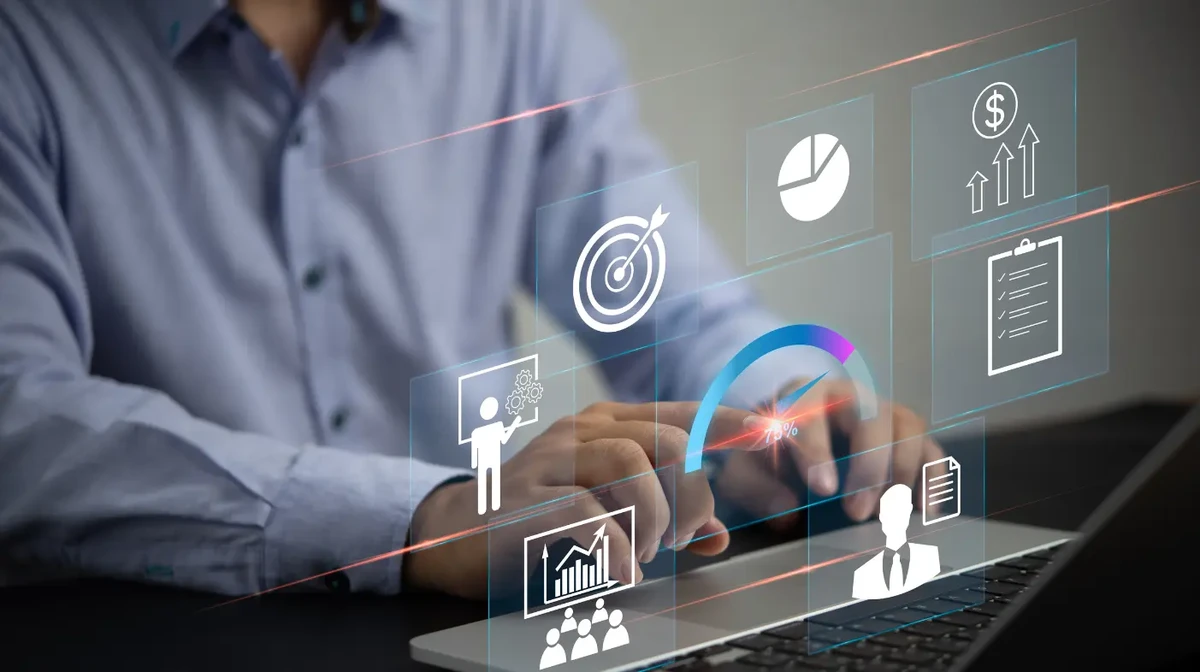 A businessman working on a laptop with modern data concepts.