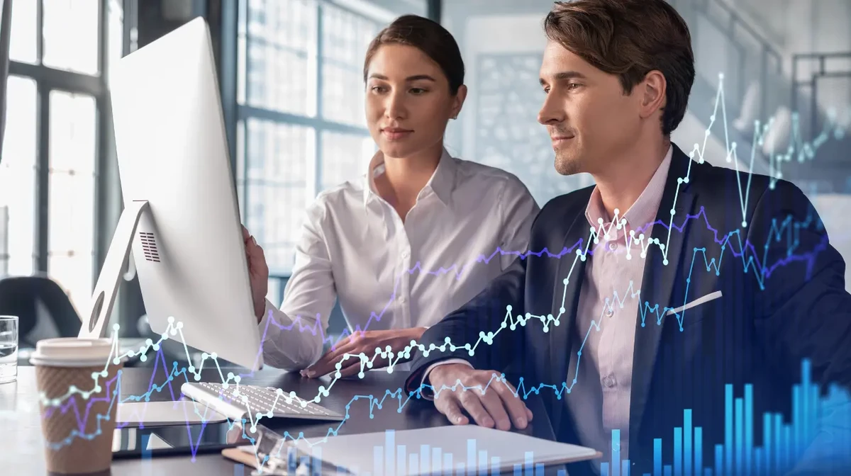 Two data engineers in an office are working to create a forecast for a project based on the available data