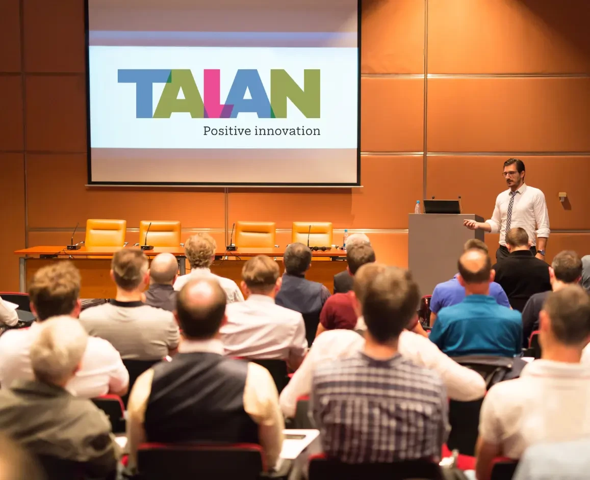 Event participants listening to a presentation by a Talan expert