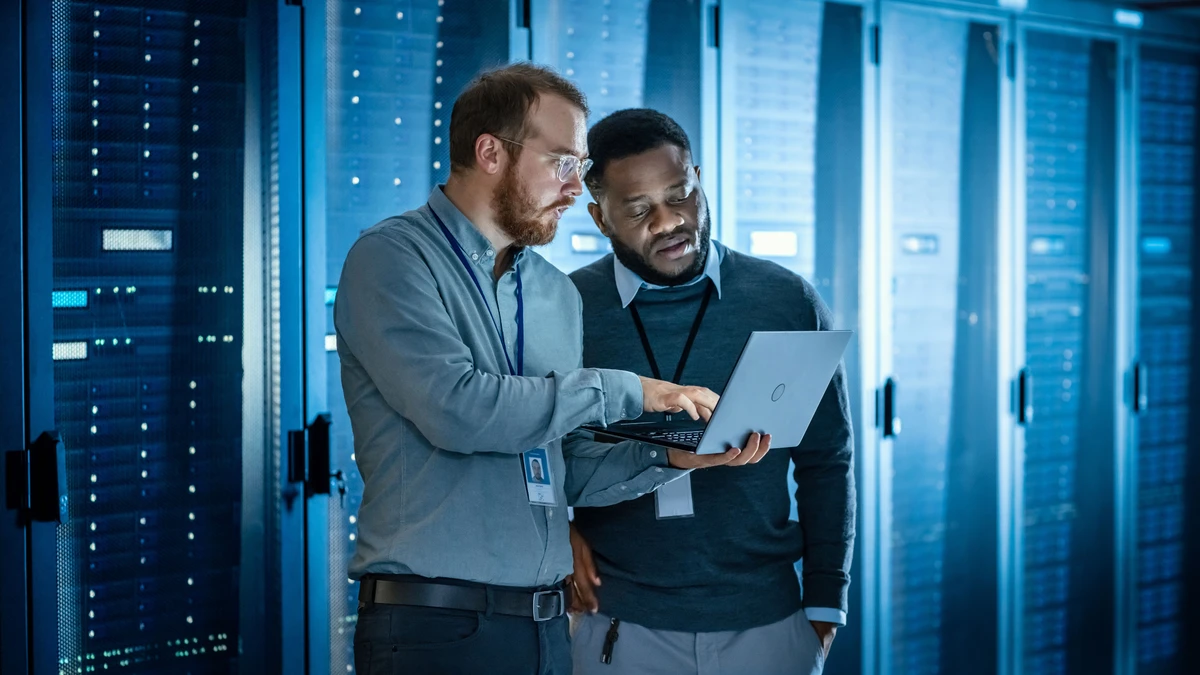 Two colleagues laptop cyber data centre server racks