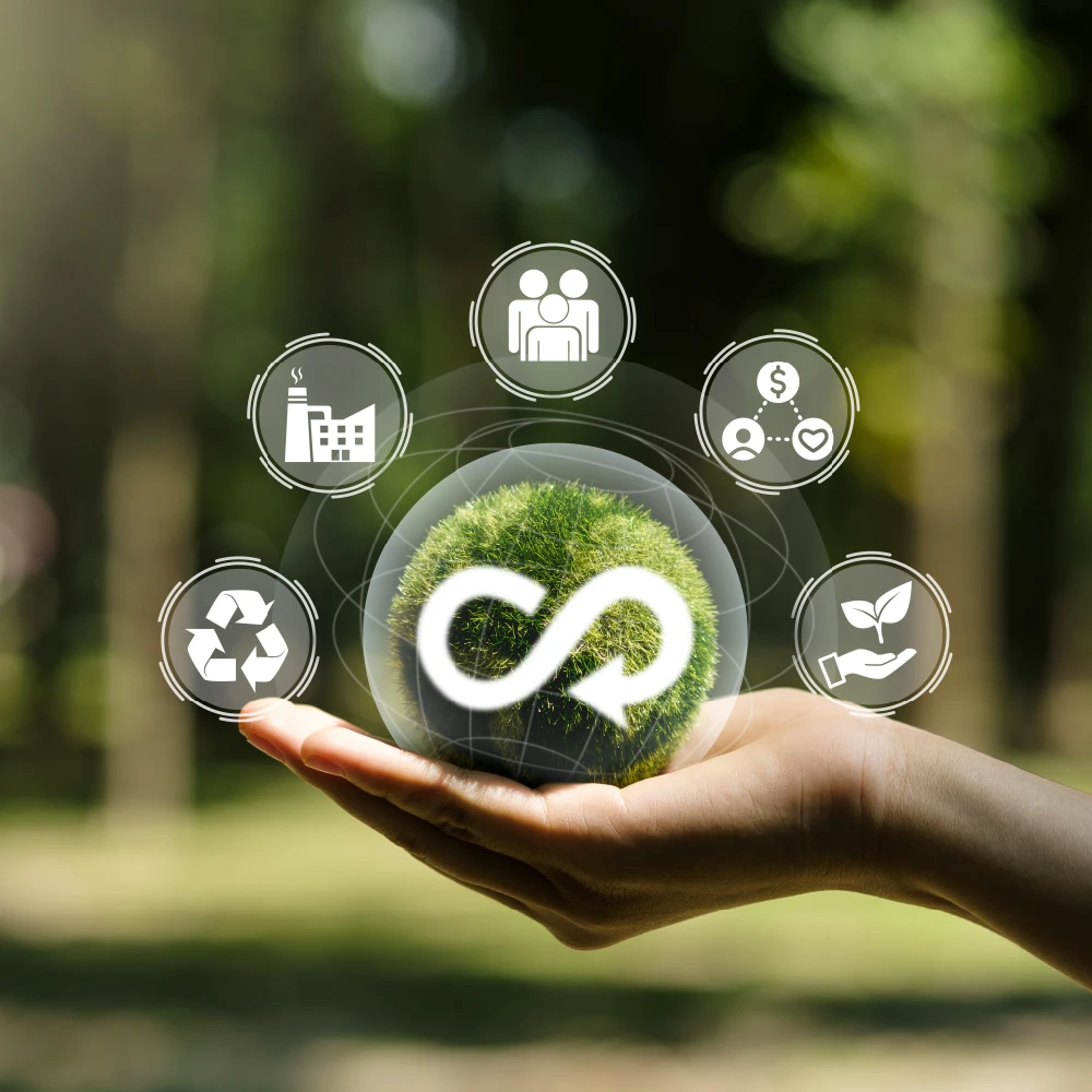 Hand holding a globe with sustainability icons.
