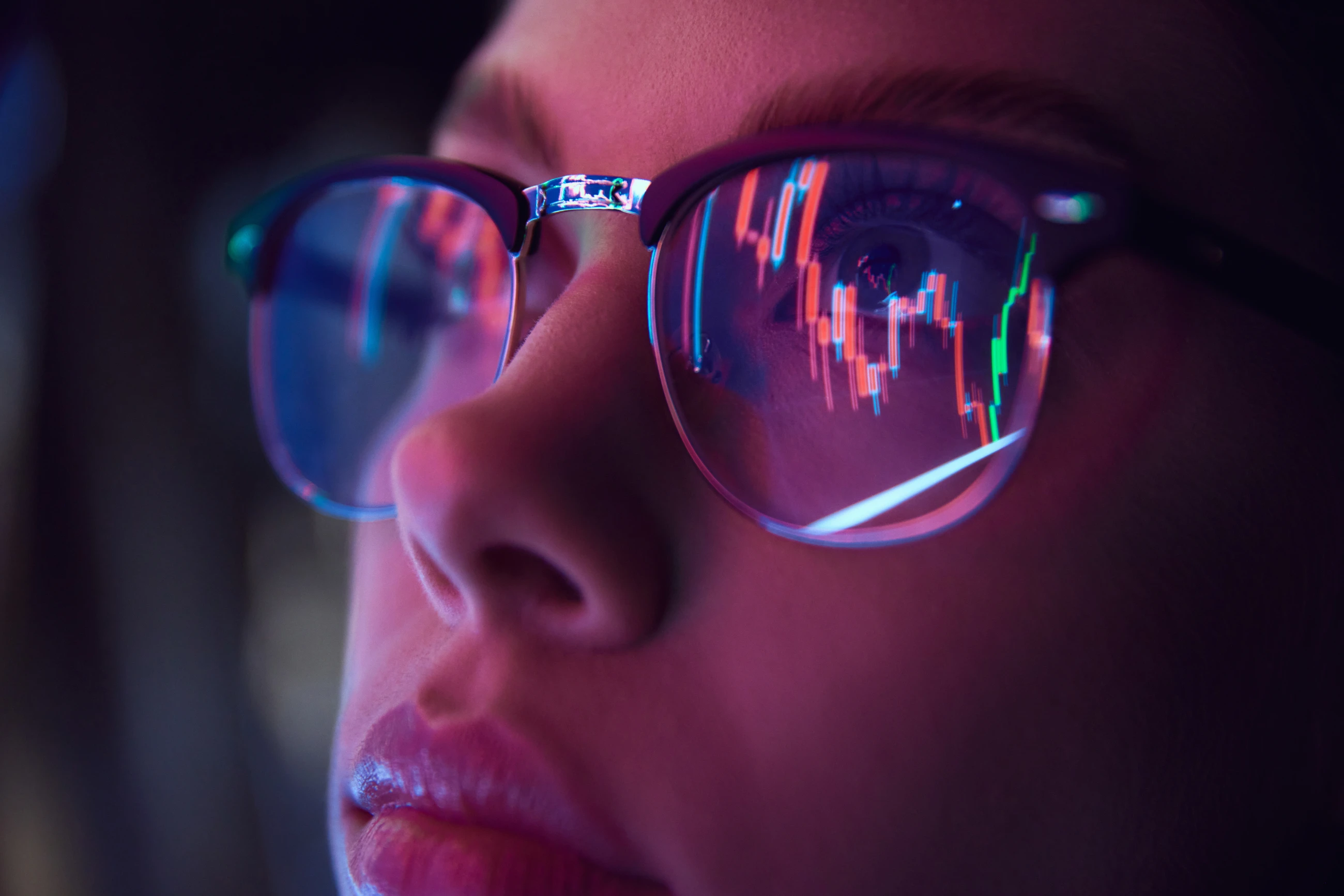 Close up view of girl&#039;s eyes in glasses with computer reflection at eyewear.