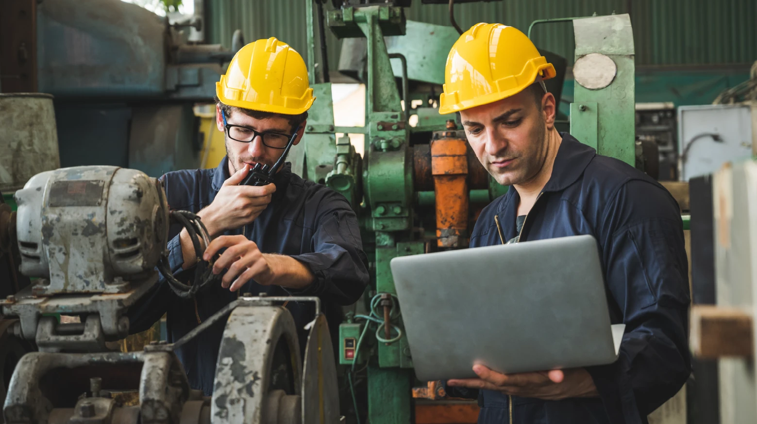 Two mine workers on computer with large excavation machines. Be bold, be gold