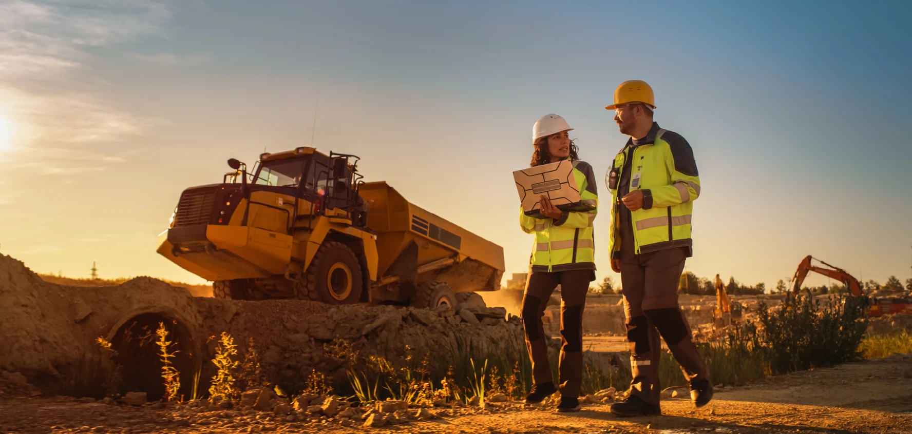 Two Talan experts guiding in a mine center. Mining excavation machines.