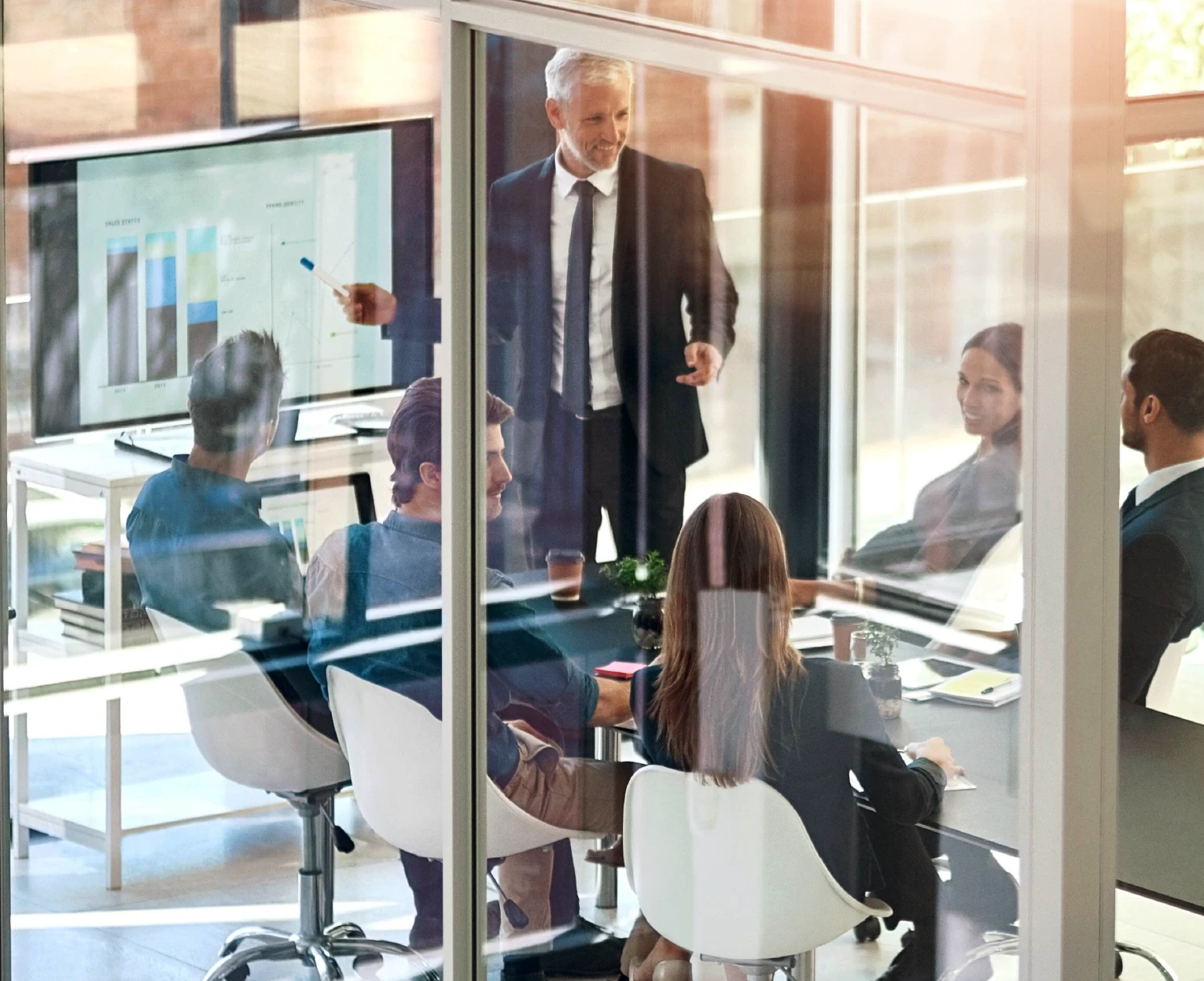 Team with potential customer in meeting inside a modern office