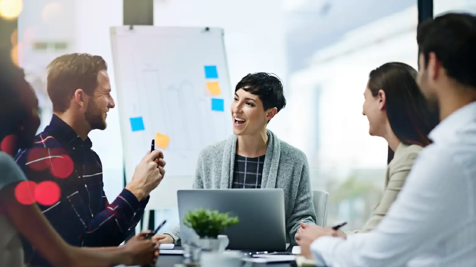 Woman programmer with her work team in a meeting
