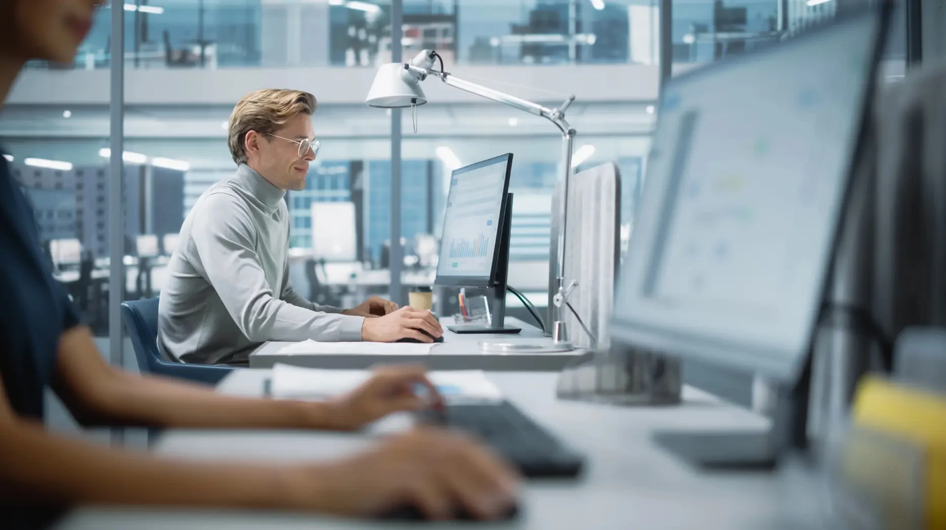 Two sernior AI developers are working on Oracle application modernization at an office