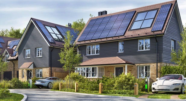 House surrounded by low carbon technology including solar panels and electric vehicles.