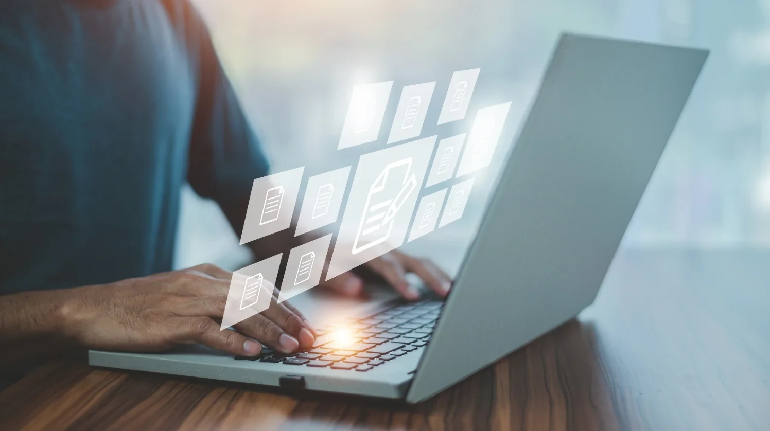 A Man is working on digital forms and documents on a laptop