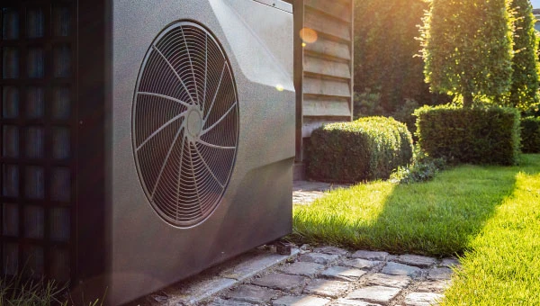 A heat pump installed on the side of a house.