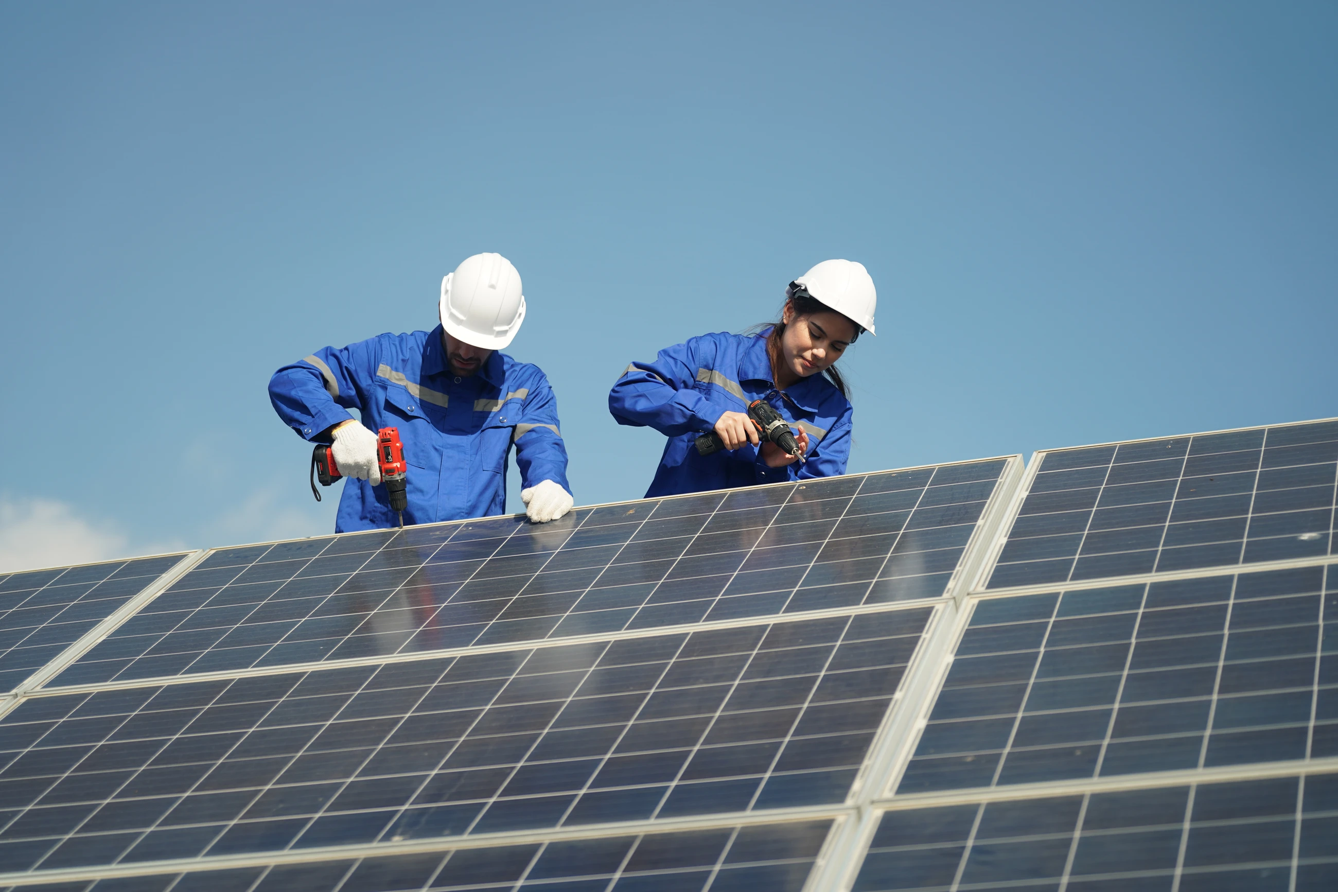 Two engineers installing a solar panel
