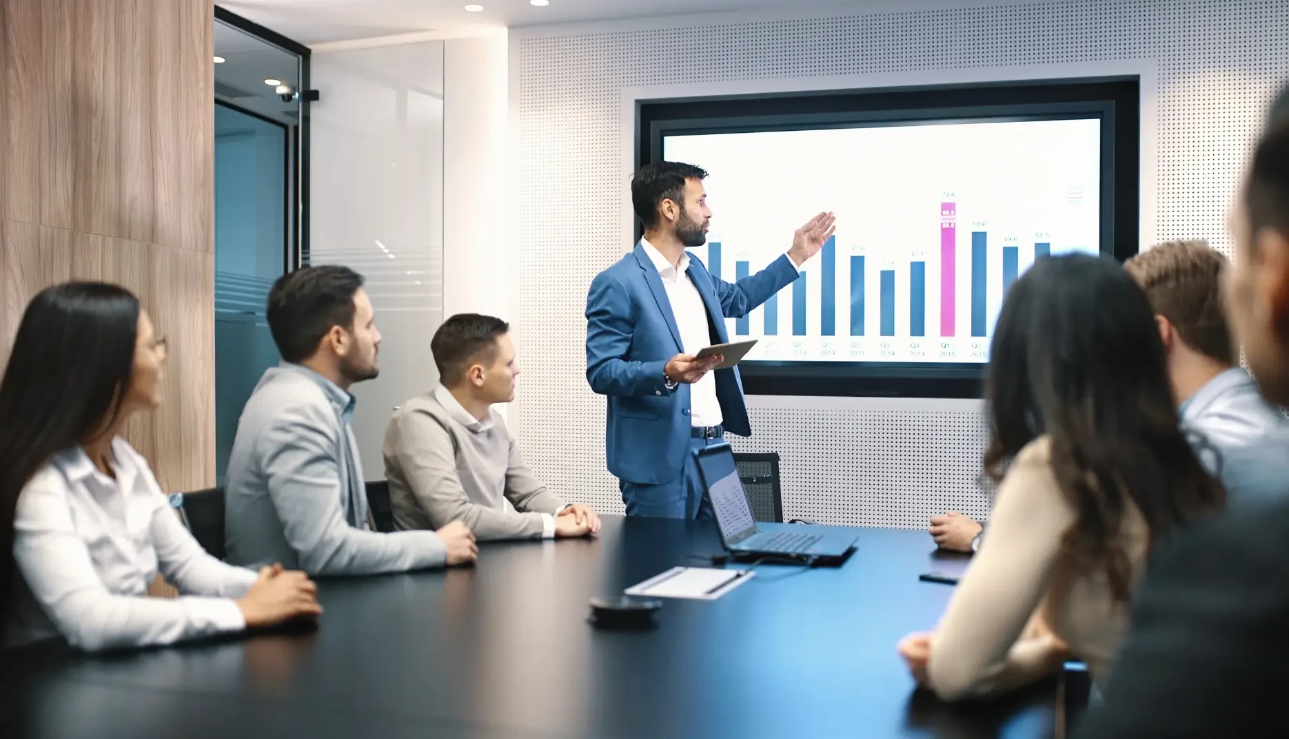 businesspeople attending to seminar in conference room