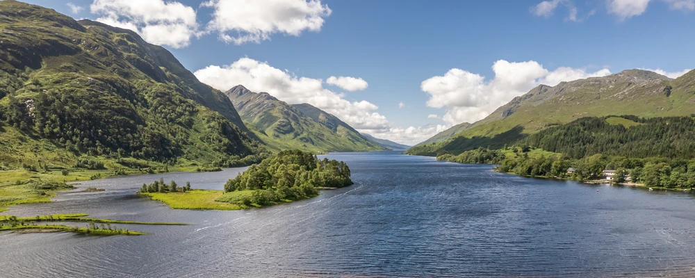 A river running through a green Scottish landscape