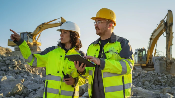 Woman and man in a mining plant maximizing production and minimizing risks in mining. 
