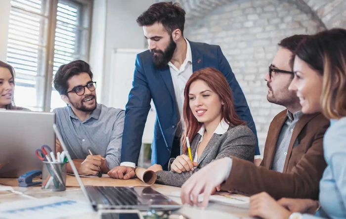 Team of people working on Microsoft platform in a modern office