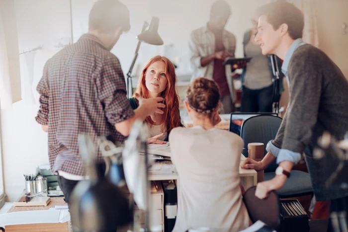 Team of young professionals working on project in office setting