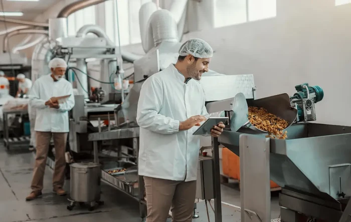 A granola and cereal manufacturing plant where a worker is inspecting a granola production line