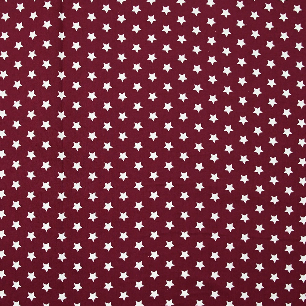 Popeline de coton imprimée étoiles fond bordeaux