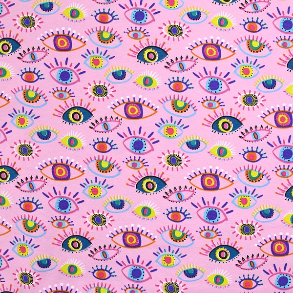 Jersey de coton imprimé yeux multicolores fond rose clair