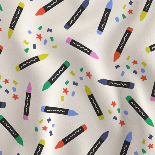 Fabric in Scattered Colored Crayons and Confetti on a Cream Background