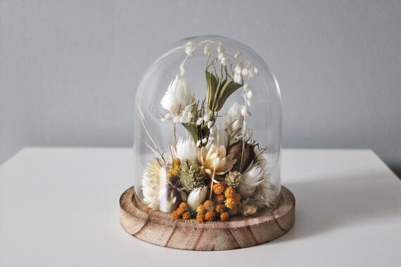 Yellow dried glass flower bell and wooden base