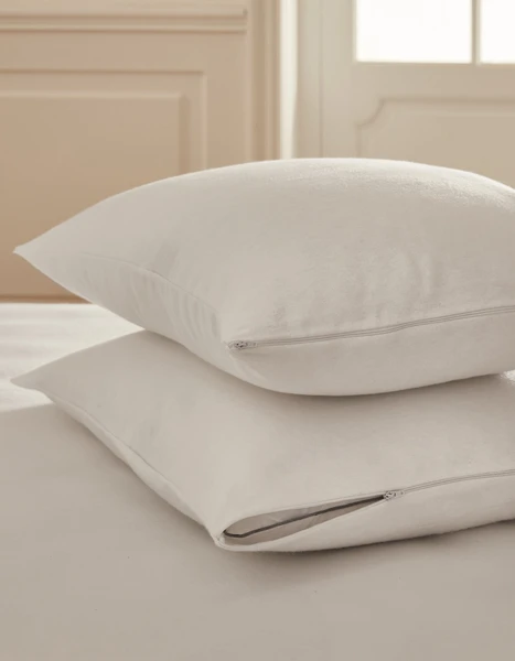 La paire de protège oreillers 100% coton